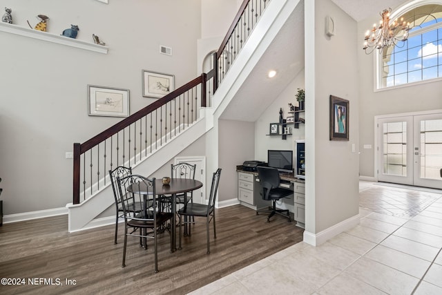 dining area featuring a chandelier, french doors, visible vents, and a high ceiling