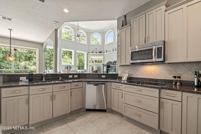 kitchen featuring stainless steel appliances, a wealth of natural light, visible vents, and tasteful backsplash