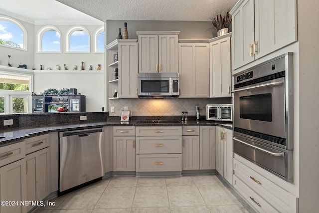 kitchen featuring stainless steel appliances, a textured ceiling, open shelves, backsplash, and a warming drawer