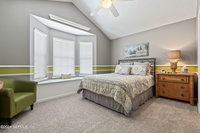 bedroom with ceiling fan, multiple windows, vaulted ceiling, and carpet flooring