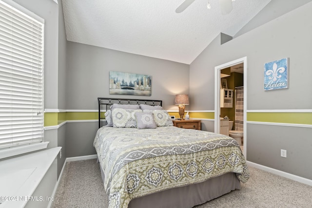 bedroom featuring a textured ceiling, carpet flooring, baseboards, vaulted ceiling, and ensuite bath