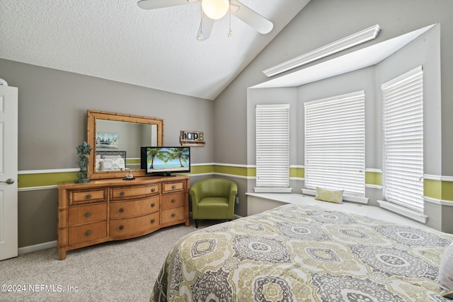 bedroom with vaulted ceiling, carpet floors, a textured ceiling, and ceiling fan