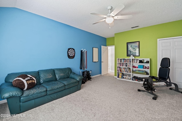 interior space with baseboards, visible vents, ceiling fan, a textured ceiling, and carpet flooring