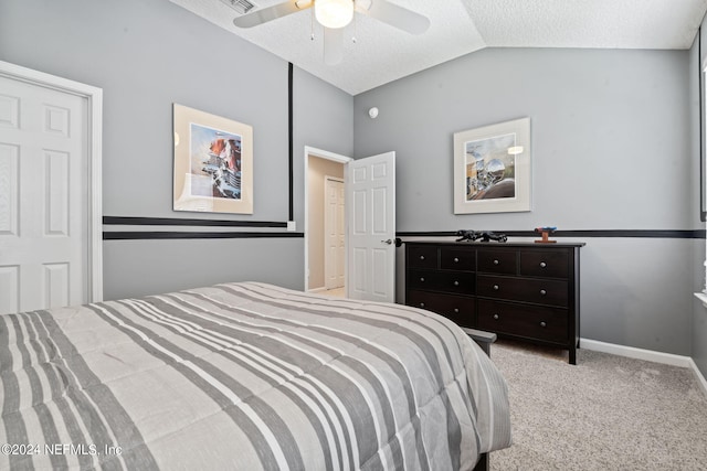 carpeted bedroom featuring visible vents, baseboards, lofted ceiling, ceiling fan, and a textured ceiling