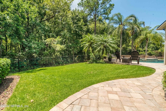 view of yard featuring a patio, a fenced backyard, and a fenced in pool