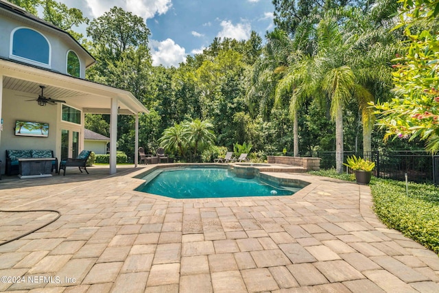 view of swimming pool with a patio, an in ground hot tub, fence, a ceiling fan, and a fenced in pool