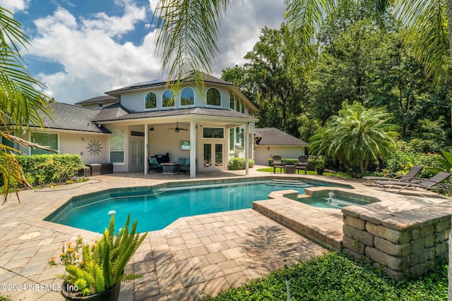 view of pool with a pool with connected hot tub, french doors, a patio, and ceiling fan