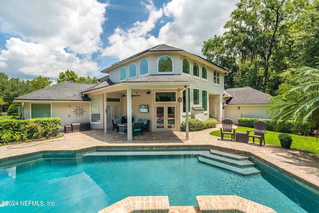 back of house with ceiling fan, a patio, a pool with connected hot tub, french doors, and roof with shingles