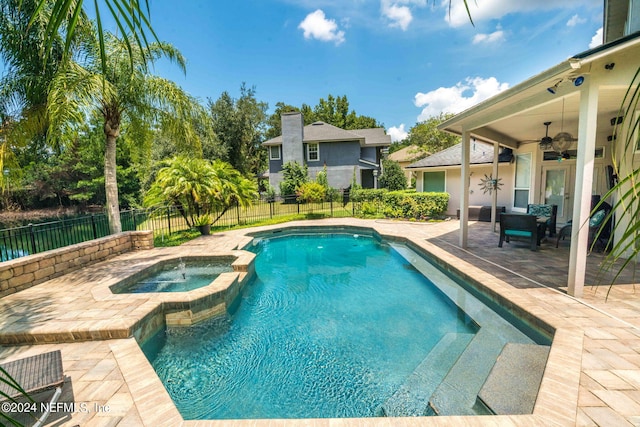 view of pool with ceiling fan, a pool with connected hot tub, a fenced backyard, and a patio