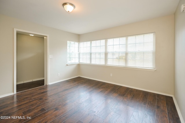 spare room with dark hardwood / wood-style floors