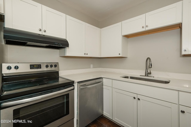 kitchen with stainless steel appliances, sink, and white cabinets