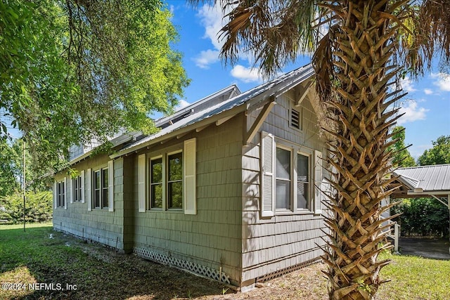 view of side of property with metal roof