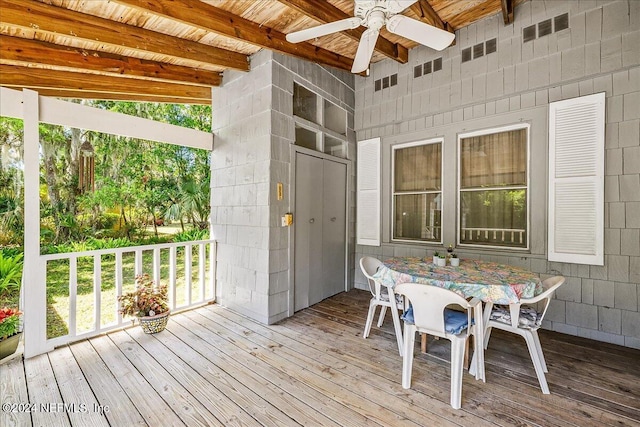 wooden terrace featuring ceiling fan and outdoor dining space