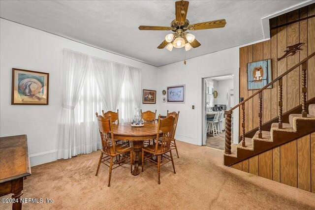 dining room featuring light colored carpet and ceiling fan