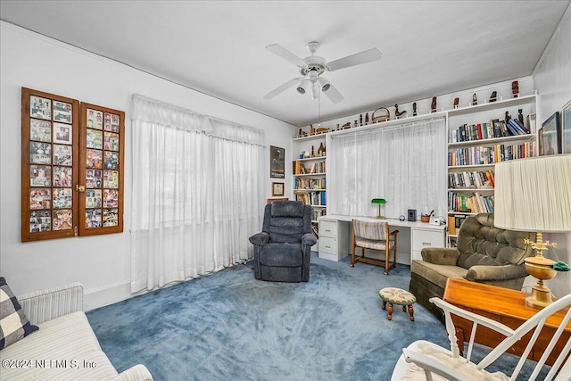 living area featuring carpet floors and ceiling fan