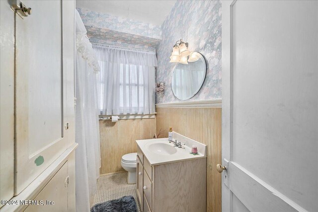 bathroom with vanity, tile patterned floors, and toilet