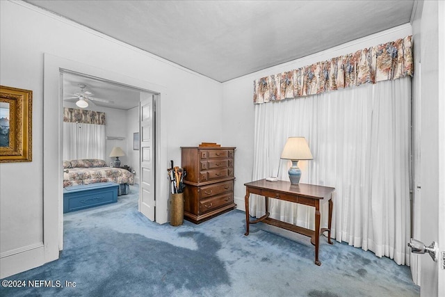 sitting room featuring a ceiling fan and carpet