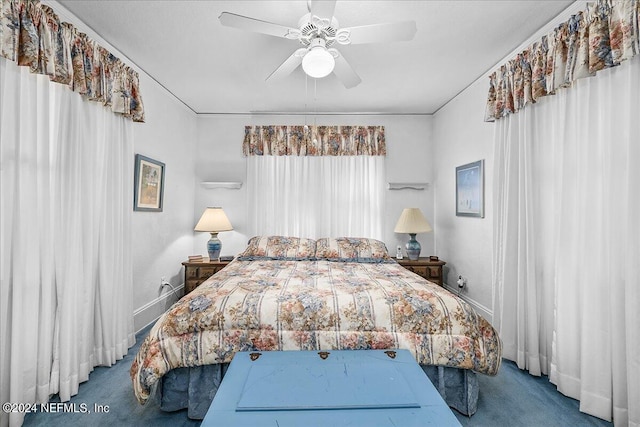 carpeted bedroom with a ceiling fan and baseboards