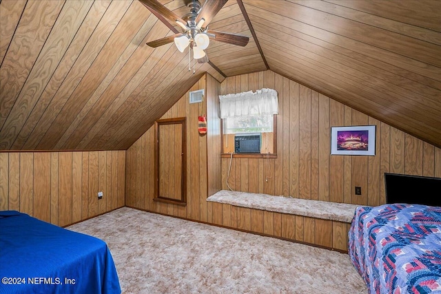 carpeted bedroom with wood walls, vaulted ceiling, wood ceiling, and ceiling fan