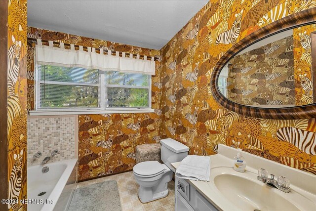 bathroom with tile patterned floors, vanity, toilet, and a wealth of natural light