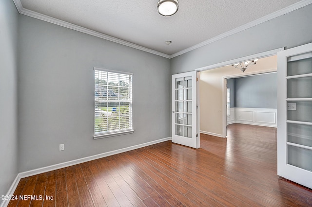 unfurnished room with wood-type flooring, ornamental molding, a textured ceiling, and french doors