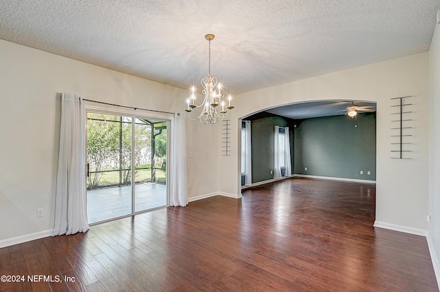 empty room with arched walkways, dark wood finished floors, a textured ceiling, baseboards, and ceiling fan with notable chandelier