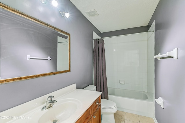 bathroom featuring toilet, shower / bath combo with shower curtain, a textured ceiling, vanity, and tile patterned floors