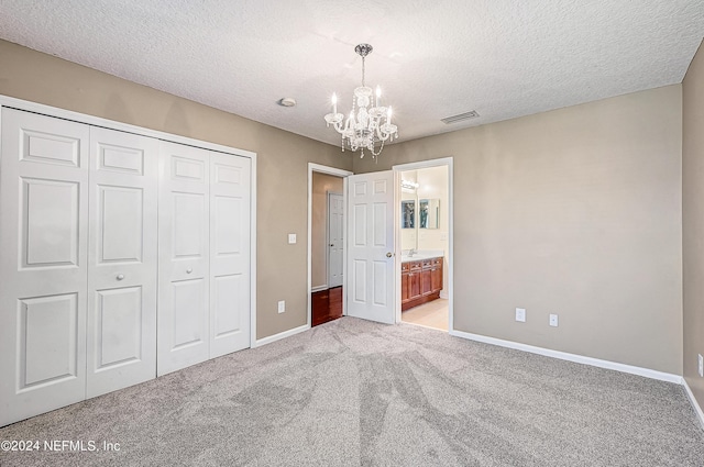 unfurnished bedroom with light colored carpet, visible vents, baseboards, a closet, and an inviting chandelier