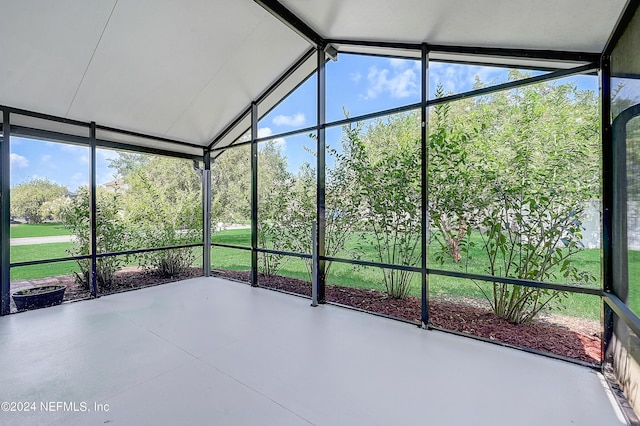 unfurnished sunroom featuring lofted ceiling