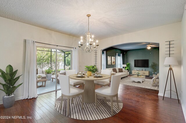 dining room featuring dark wood-type flooring, a textured ceiling, and ceiling fan with notable chandelier