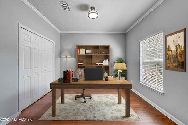 office space with crown molding, visible vents, a textured ceiling, wood finished floors, and baseboards