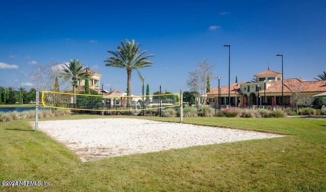 surrounding community featuring a lawn and volleyball court