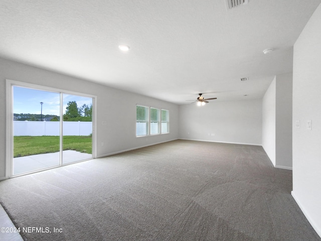 unfurnished room with a water view, carpet floors, and ceiling fan