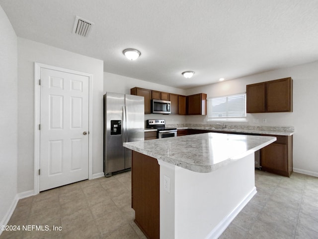 kitchen with sink, a center island, and appliances with stainless steel finishes