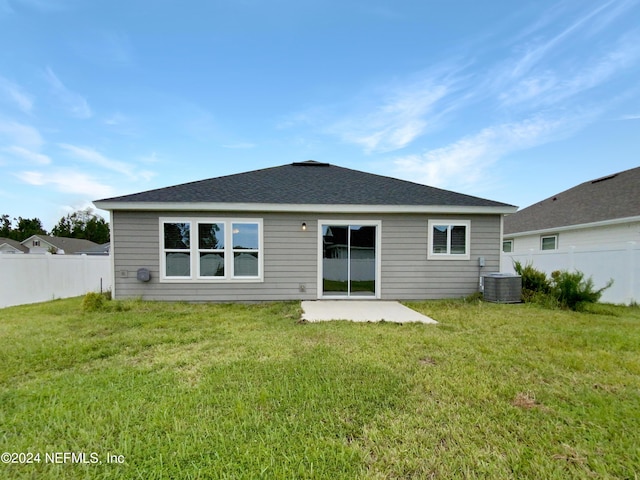 rear view of property featuring a yard, a patio area, and central air condition unit