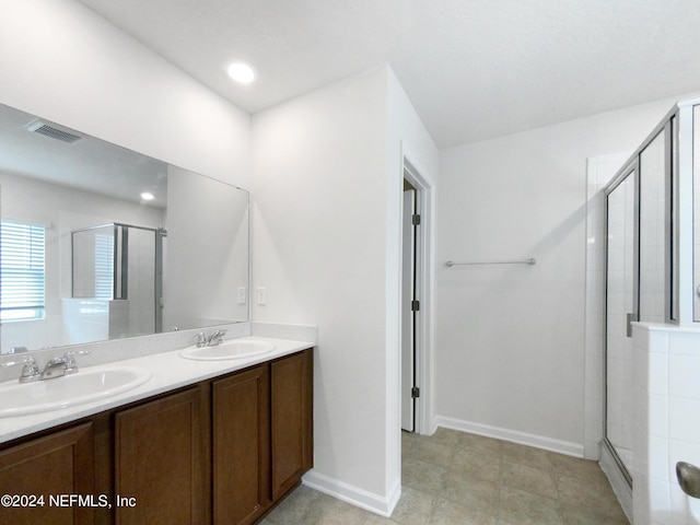 bathroom featuring vanity and a shower with door