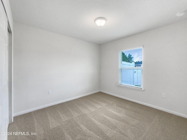 empty room featuring carpet flooring