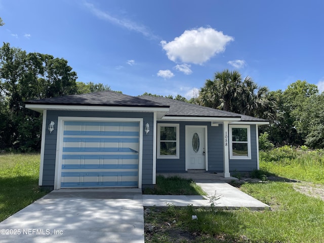 1058 W 17th St, Jacksonville, FL 32209 - view of front of house with concrete driveway and a garage