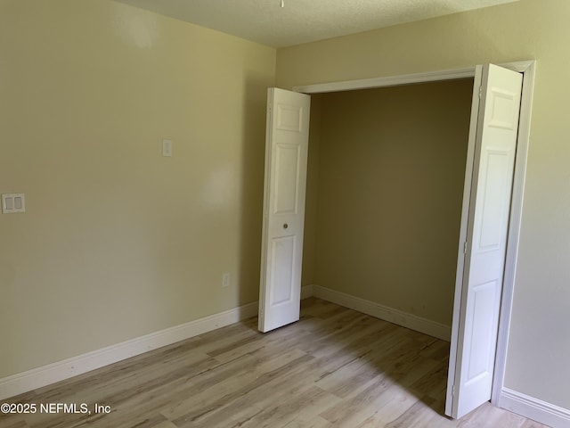 1058 W 17th St, Jacksonville, FL 32209 - unfurnished bedroom featuring baseboards and light wood-type flooring