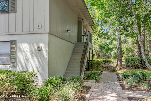 view of side of home with stairs