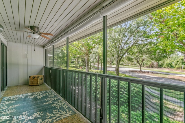 unfurnished sunroom featuring a ceiling fan