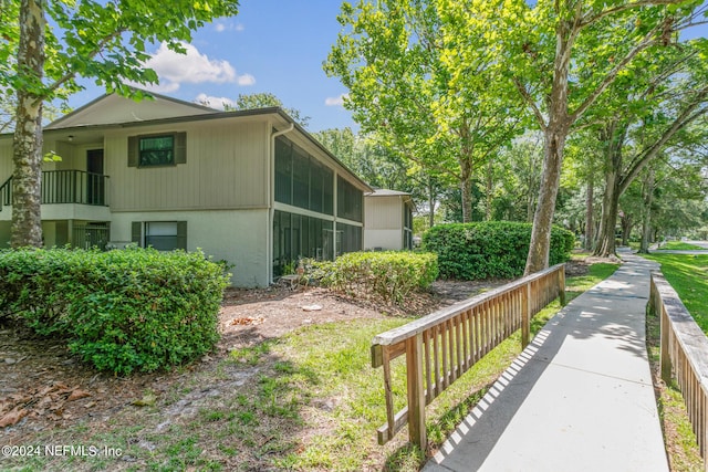 view of side of home featuring fence