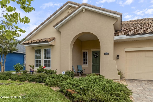 doorway to property with a garage