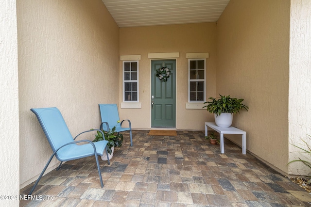 entrance to property with a patio