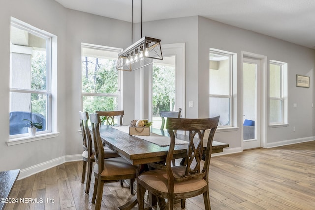 dining area featuring light hardwood / wood-style floors and a chandelier