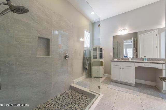 bathroom featuring vanity and tiled shower