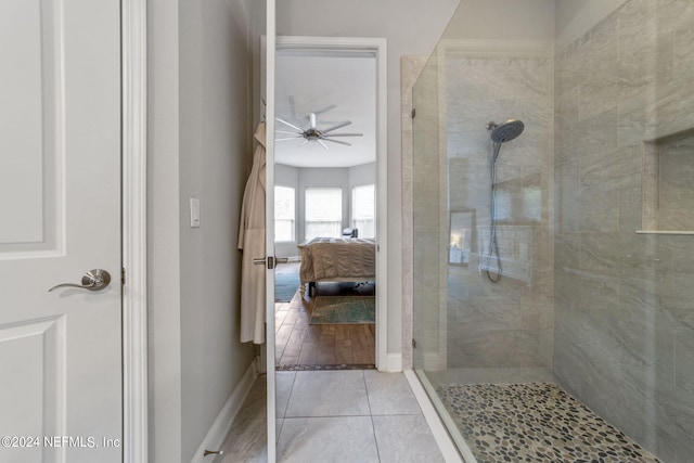 bathroom with ceiling fan, tile patterned flooring, and a tile shower