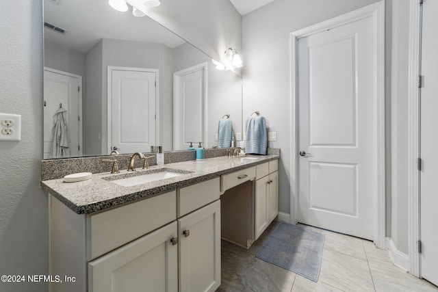 bathroom with tile patterned floors and vanity