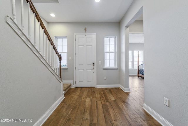 foyer with dark hardwood / wood-style floors