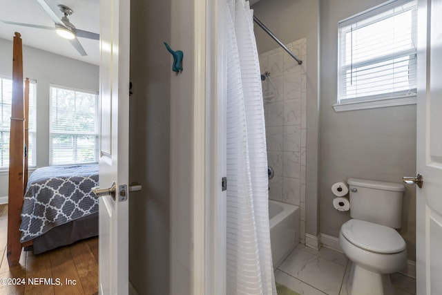 bathroom with ceiling fan, shower / bath combo, toilet, and a wealth of natural light